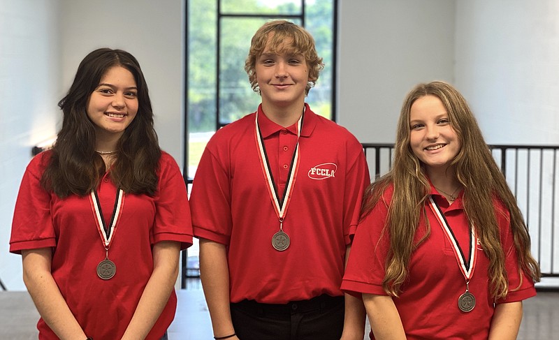 From left, Elvira Yanes, Hayden Cullins and Anne-Elise Brammer were part of the Hot Springs Junior Academy's Family, Career and Community Leaders of America team that competed in a Students Taking Action with Recognition event. - Photo by John Anderson of The Sentinel-Record