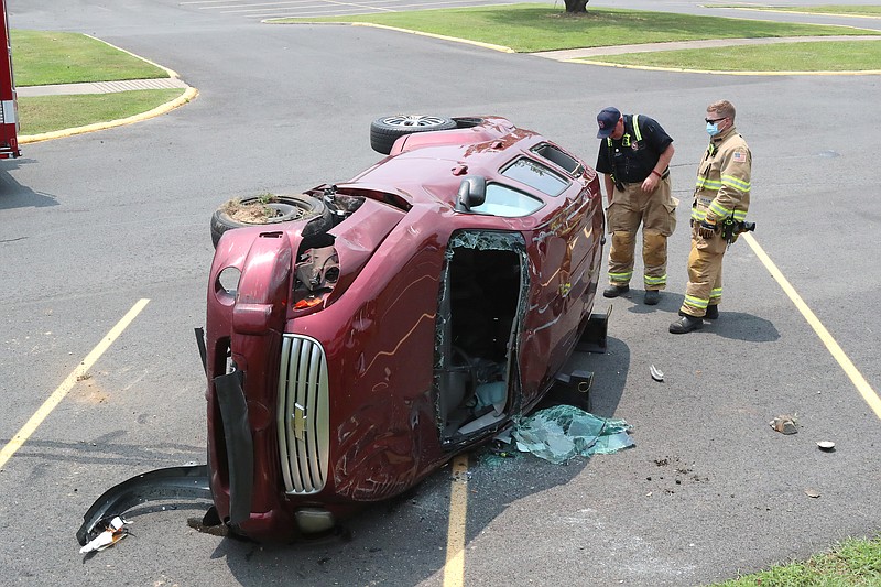 Hot Springs Fire Department personnel work a single-vehicle wreck that occurred around 12:30 p.m. Tuesday in the 700 block of Emory Street. - Photo by Richard Rasmussen of The Sentinel-Record