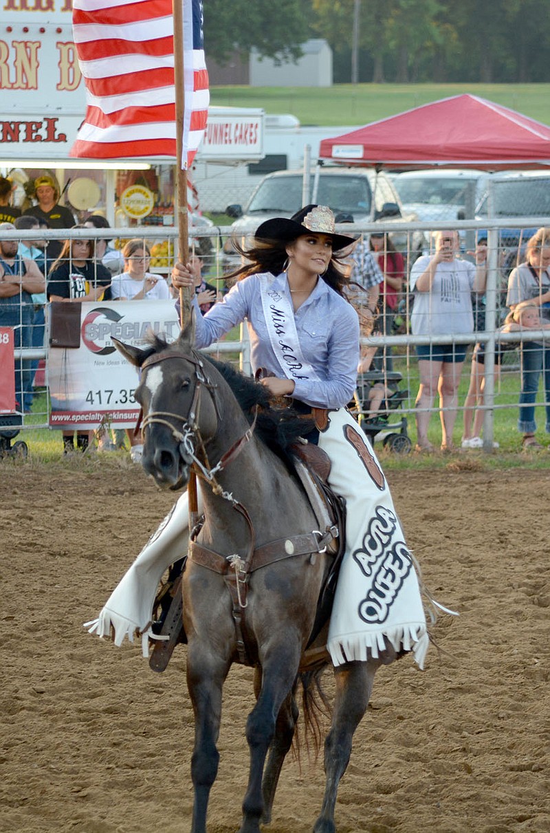 Graham Thomas/Siloam Sunday
Allie Baker, ACRA Rodeo Queen of Pawhuska, Okla., presents the American flag for the national anthem on Thursday at the 63rd annual Siloam Springs Rodeo.
