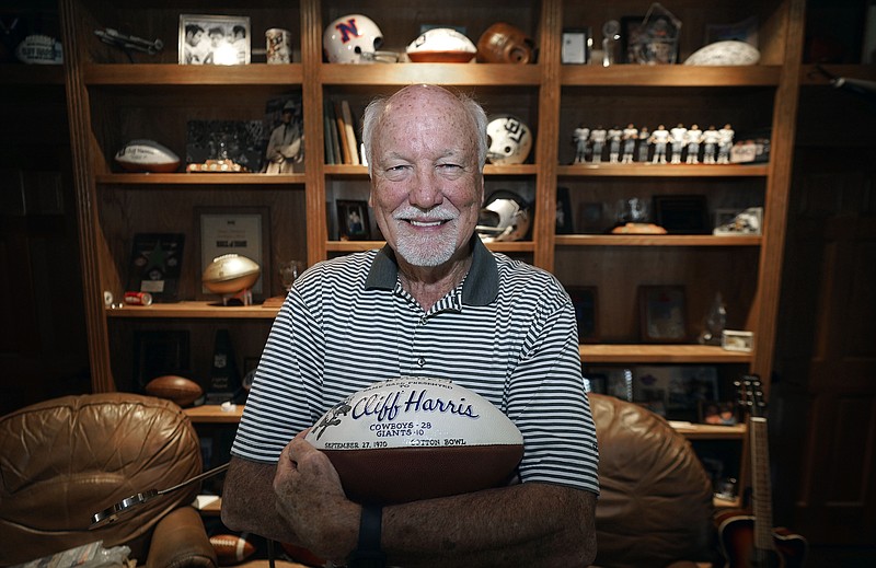 Former Dallas Cowboys and NFL football great Cliff Harris displays a commemorative football from his second professional game at his home in North Dallas on June 30. Harris is one of the two undrafted Cowboys among their 15 players in the Hall of Fame. - Photo by LM Otero of The Associated Press