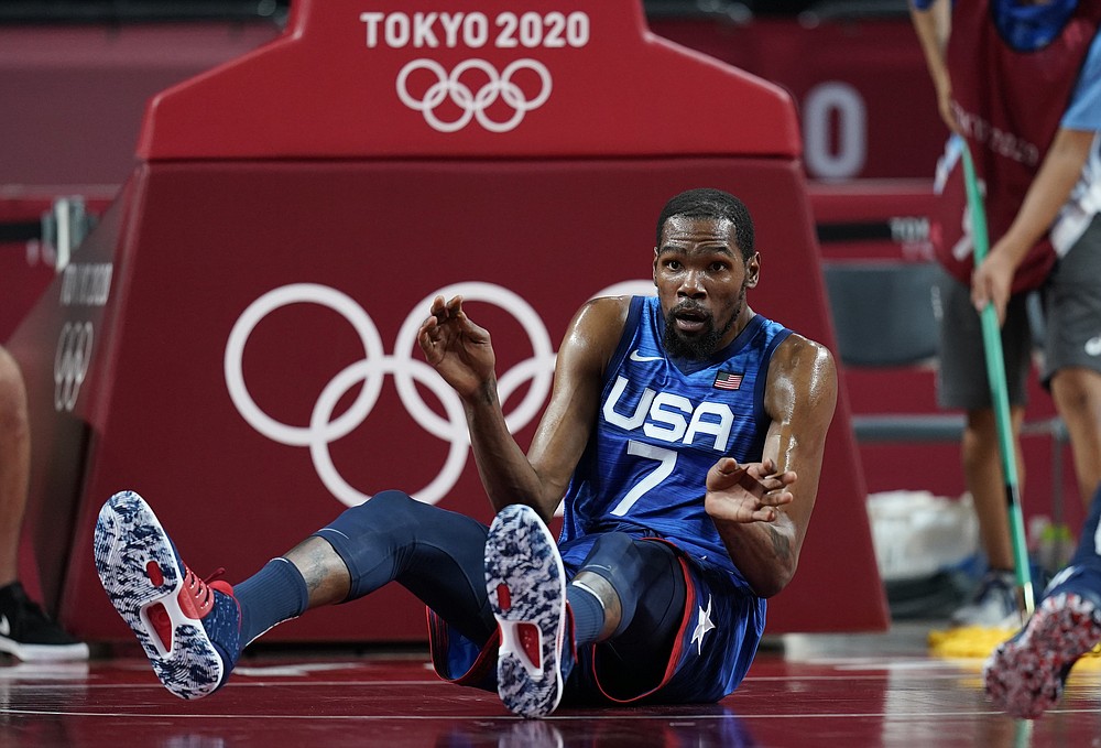 United States' Kevin Durant (7) reacts after falling on the court in an attempt to take control of the ball during men's basketball quarterfinal game against Spain at the 2020 Summer Olympics, Tuesday, Aug. 3, 2021, in Saitama, Japan. (AP Photo/Charlie Neibergall)