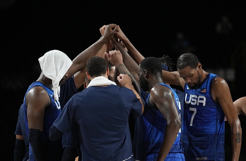 United States' Kevin Durant (7), right, and teammates celebrate their win in the men's basketball quarterfinal game against Spain at the 2020 Summer Olympics, Tuesday, Aug. 3, 2021, in Saitama, Japan. (AP Photo/Eric Gay)