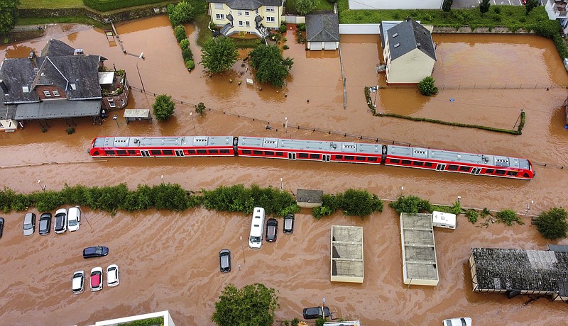 In this July 15 file photo, a regional train in the flood waters at the local station in Kordel, Germany, after it was flooded by the high waters of the Kyll river. This summer a lot of the places hit by weather disasters are not used to getting extremes and many of them are wealthier, which is different from the normal climate change victims. That includes unprecedented deadly flooding in Germany and Belgium, 116-degree heat records in Portland, Oregon and similar blistering temperatures in Canada, along with wildfires. Now Southern Europe is seeing scorching temperatures and out-of-control blazes too. And the summer of extremes is only getting started. Peak Atlantic hurricane and wildfire seasons in the United States are knocking at the door. - Sebastian Schmitt/dpa via AP