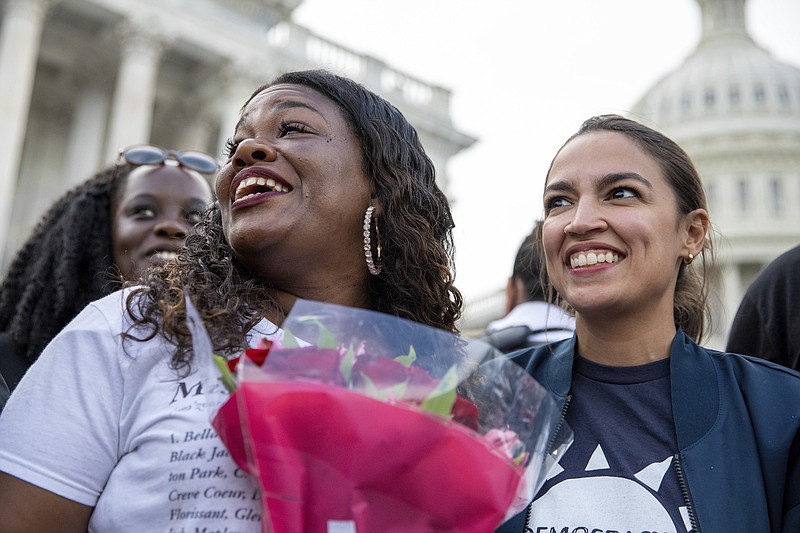 Rep. Cori Bush, D-Mo., and Rep. Alexandria Ocasio-Cortez, D-N.Y., smile after it was announced that the Biden administration will enact a targeted nationwide eviction moratorium outside of Capitol Hill in Washington on Tuesday, August 3, 2021. For the past five days, lawmakers and activists primarily led by Rep. Cori Bush, D-Mo., have been sitting in on the steps of Capitol Hill to protest the expiration of the eviction moratorium. (AP Photo/Amanda Andrade-Rhoades)