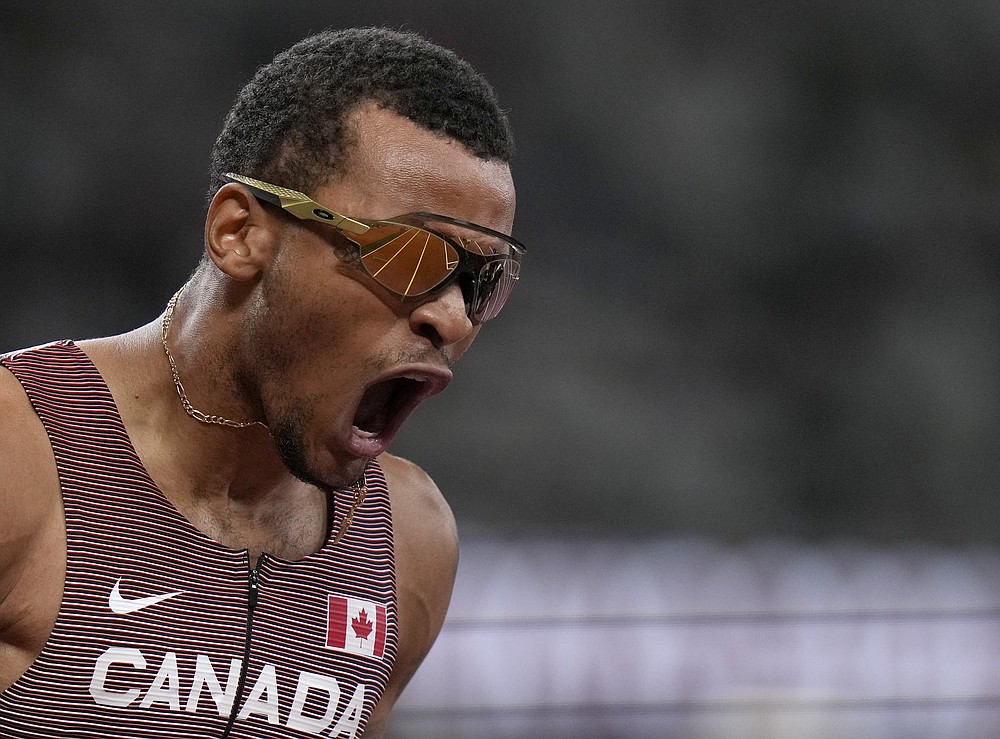Andre De Grasse, of Canada celebrates after he won the gold medal in the final of the men's 200-meters at the 2020 Summer Olympics, Wednesday, Aug. 4, 2021, in Tokyo, Japan. (AP Photo/Francisco Seco)