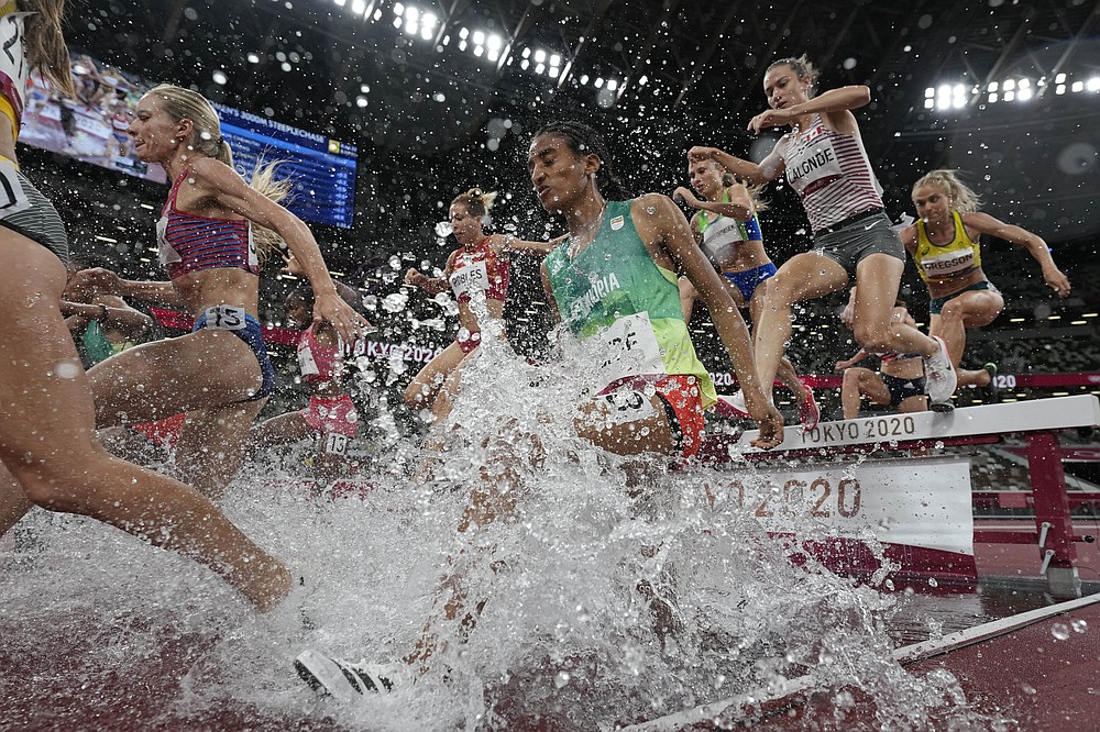 Runners compete in the final of the women's 3,000-meters steeplechase at the 2020 Summer Olympics, Wednesday, Aug. 4, 2021, in Tokyo. (AP Photo/David J. Phillip)