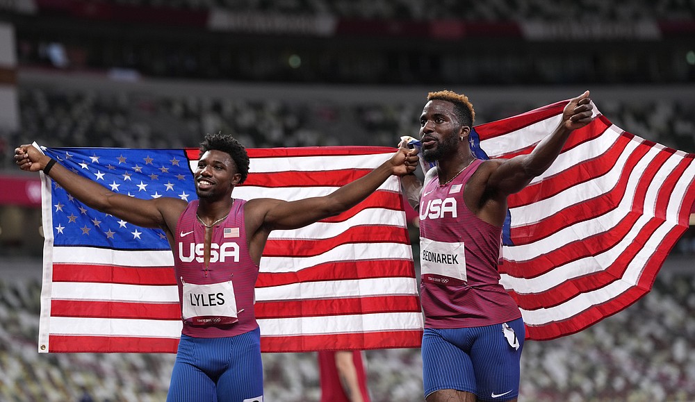 Kenneth Bednarek, of United States, silver, and Noah Lyles, of United States, bronze, react after the final of the men's 200-meters at the 2020 Summer Olympics, Wednesday, Aug. 4, 2021, in Tokyo, Japan. (AP Photo/Francisco Seco)
