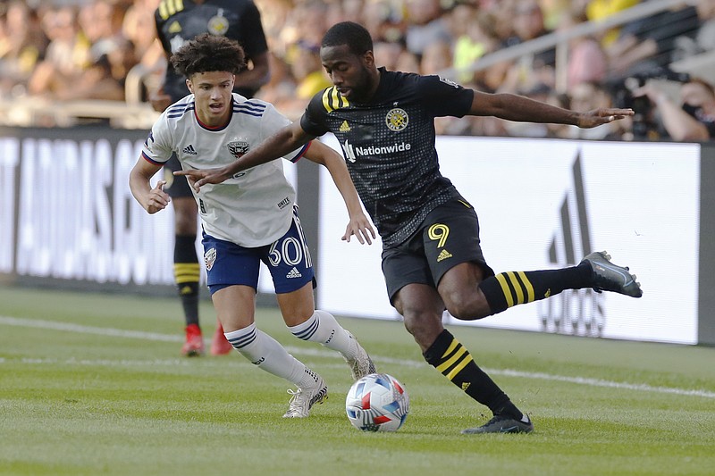 Columbus Crew's Kevin Molino, right, dribbles the ball next to D.C. United's Kevin Paredes during the first half of Wednesday's MLS match in Columbus, Ohio. - Photo by Jay LaPrete of The Associated Press