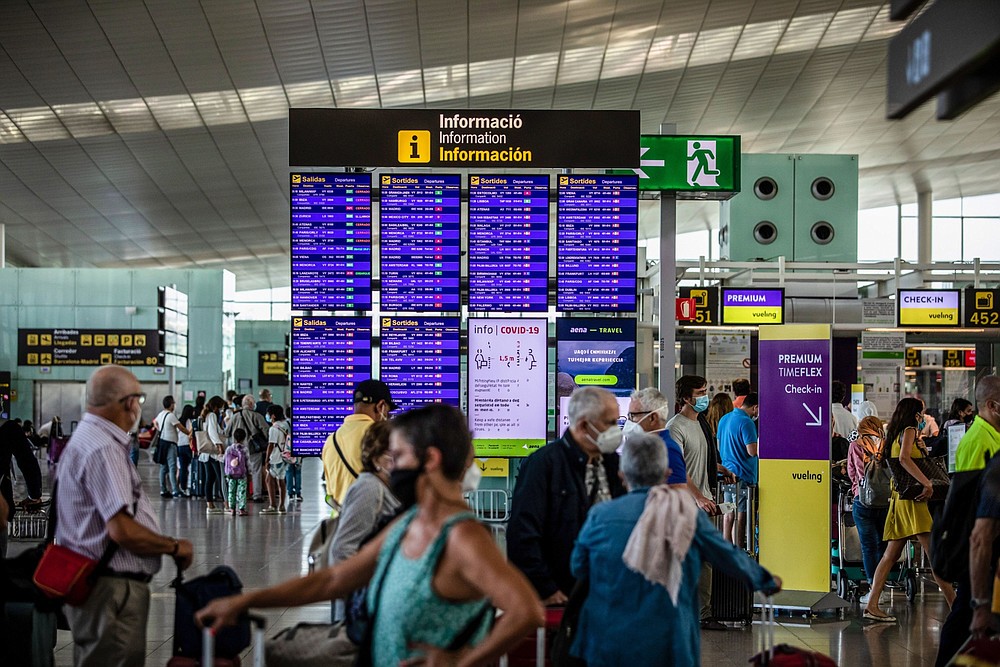 Passengers wait in the departures hall at El Prat airport in Barcelona, Spain, on Aug. 2. (Bloomberg/Angel Garcia)