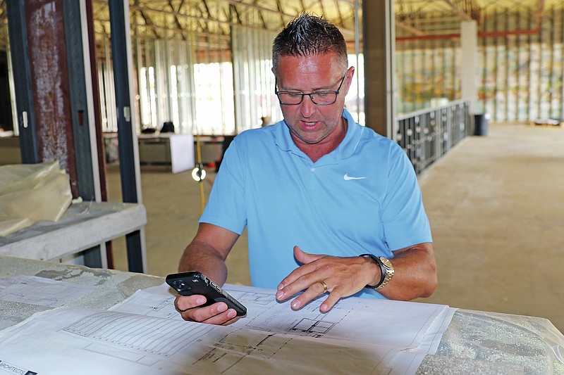 Jason Strickland/News Tribune
Scot Drinkard, co-owner of the former Capital Bowl building, looks over the blueprints Thursday for a business at 2017 Christy Dr. that'll feature 16 bowling lanes and various gaming areas. The business is sxpected to be open at the beginning of 2022.
