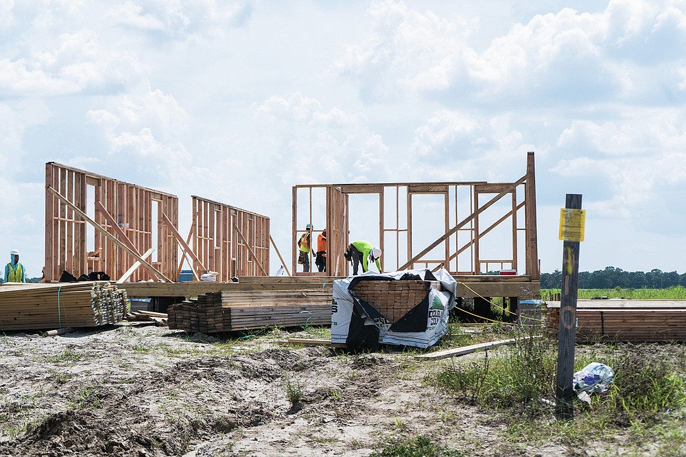 Roy Wright, left, president and CEO of the Insurance Institute for Business Home Safety, talks with Louisiana Office of Community Development Executive Director Pat Forbes about the ongoing redevelopment program Wednesday, July 28, 2021 at the New Isle community in Schriever, La. (Kezia Setyawan/Daily Comet via AP)