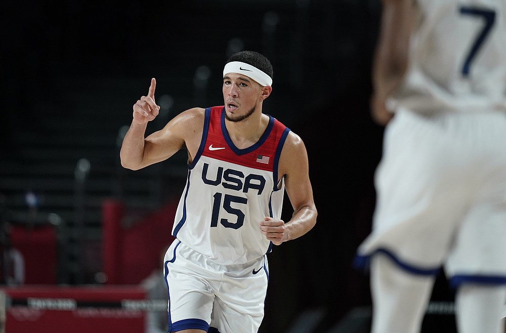 United States's Devin Booker (15) celebrates after three point basket during men's basketball semifinal game against Australia at the 2020 Summer Olympics, Thursday, Aug. 5, 2021, in Saitama, Japan. (AP Photo/Charlie Neibergall)