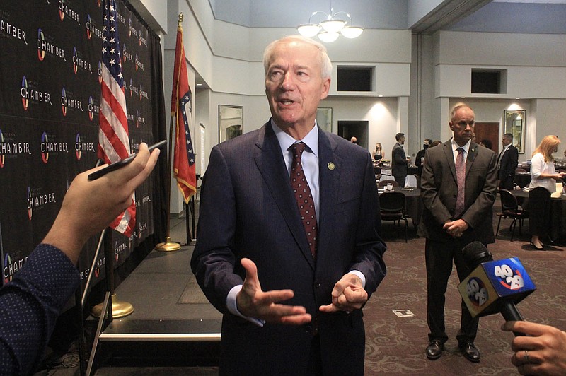 Gov. Asa Hutchinson speaks Friday to the media following an address at the Fort Smith Regional Chamber of Commerce’s First Friday Breakfast at the University of Arkansas-Fort Smith.
(NWA Democrat-Gazette/Max Bryan)