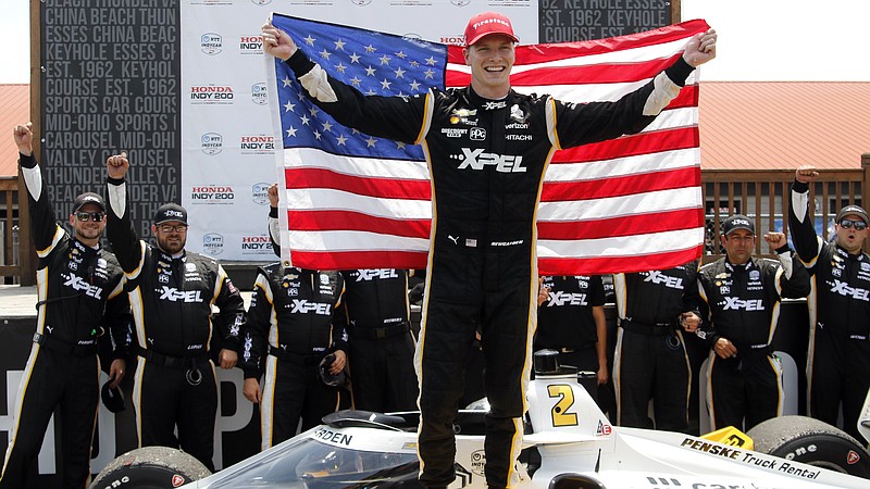 FILE - In this July 4, 2021 file photo, Josef Newgarden celebrates in victory lane after winning an IndyCar race at Mid-Ohio Sports Car Course in Lexington, Ohio.  Newgarden is the toast of Nashville. The Tennessee native has hustled from event to event to promote the IndyCar race held on the city streets.  (AP Photo/Tom E. Puskar, File)