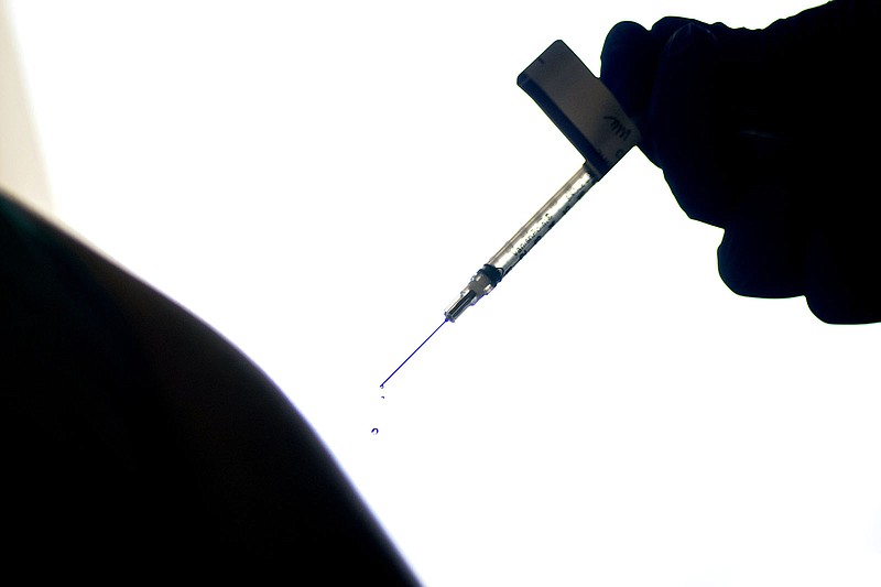 FILE - In this Dec. 15, 2020, file photo, a droplet falls from a syringe after a health care worker was injected with the Pfizer COVID-19 vaccine at a hospital in Providence, R.I. (AP Photo/David Goldman, File)