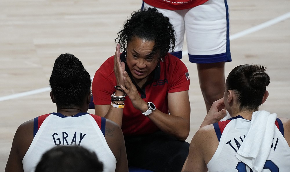 United States' head coach Dawn Staley, center, talks to the players during women's basketball gold medal game against Japan at the 2020 Summer Olympics, Sunday, Aug. 8, 2021, in Saitama, Japan. (AP Photo/Luca Bruno)