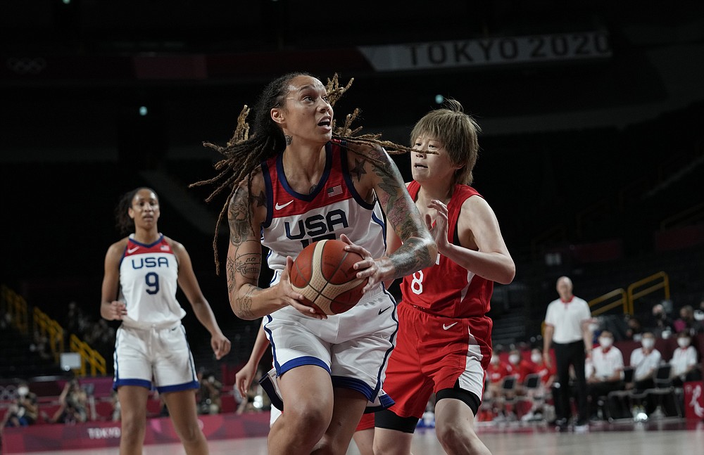 United States' Brittney Griner (15), center, drives Japan's Maki Takada (8) during women's basketball gold medal game at the 2020 Summer Olympics, Sunday, Aug. 8, 2021, in Saitama, Japan. (AP Photo/Eric Gay)