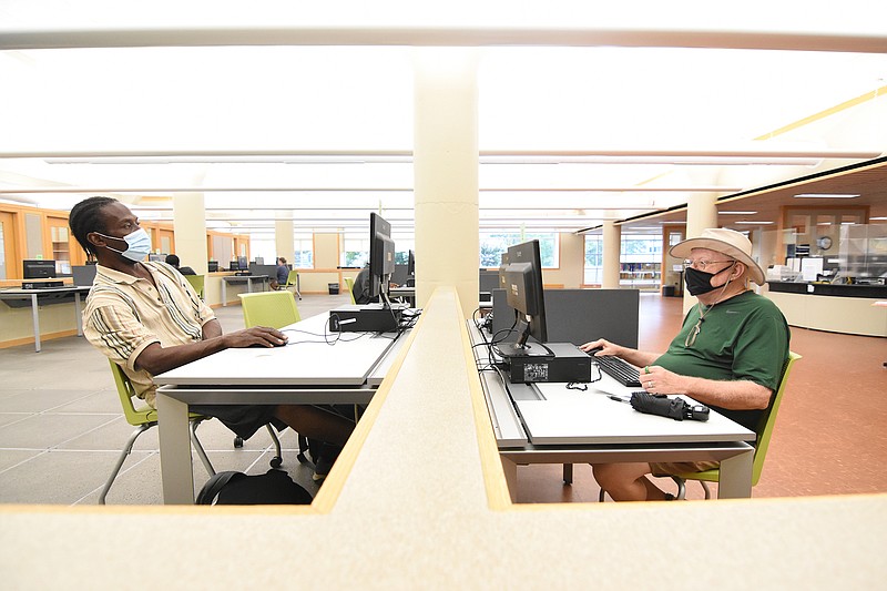 Allen Clemons, left, and Tom Adams, both of Little Rock, use computers Friday, Aug. 6, 2021 at the Central Arkansas Library System Main Library in downtown Little Rock.
(Arkansas Democrat-Gazette/Staci Vandagriff)