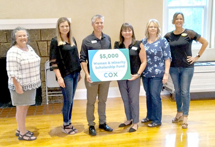 Marc Hayot/Herald-Leader Julie Chandler (left), the owner of Creative Corner on Broadway poses with Lindsey Taylor, director of community outreach for the Siloam Springs Chamber of Commerce; Arthur Hulbert, chamber president and CEO; Whitney Yoder, Arkansas public affairs manager for Cox Communications; Kimmie Provost, executive assistant to the CEO of Simmons Foods and a chamber board member; and Cammi Heavener, a realtor at Ward Jones Realtors Inc. at First Friday Coffee on Aug. 6 at the Siloam Springs Community Buildin where Cox Communications presented a $5,000 check to the chamber for the chamber's Women and Minority Scholarship Fund. The fund was created to help women and minority businesses access funds and business resources not usually have access to, said Hulbert.