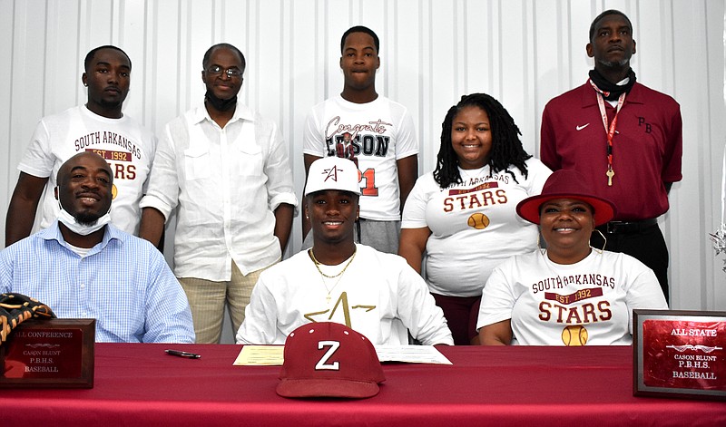 Surrounding South Arkansas Community College signee Cason Blunt are: clockwise from lower left, father Christopher Blunt Sr., brother Christopher Blunt Jr., uncle Clifton Blunt, brother Chandler Blunt, sister Kialandrea Kilpatrick, Pine Bluff High School Coach Ryan Stinson and mother Chere Minor. (Pine Bluff Commercial/I.C. Murrell)