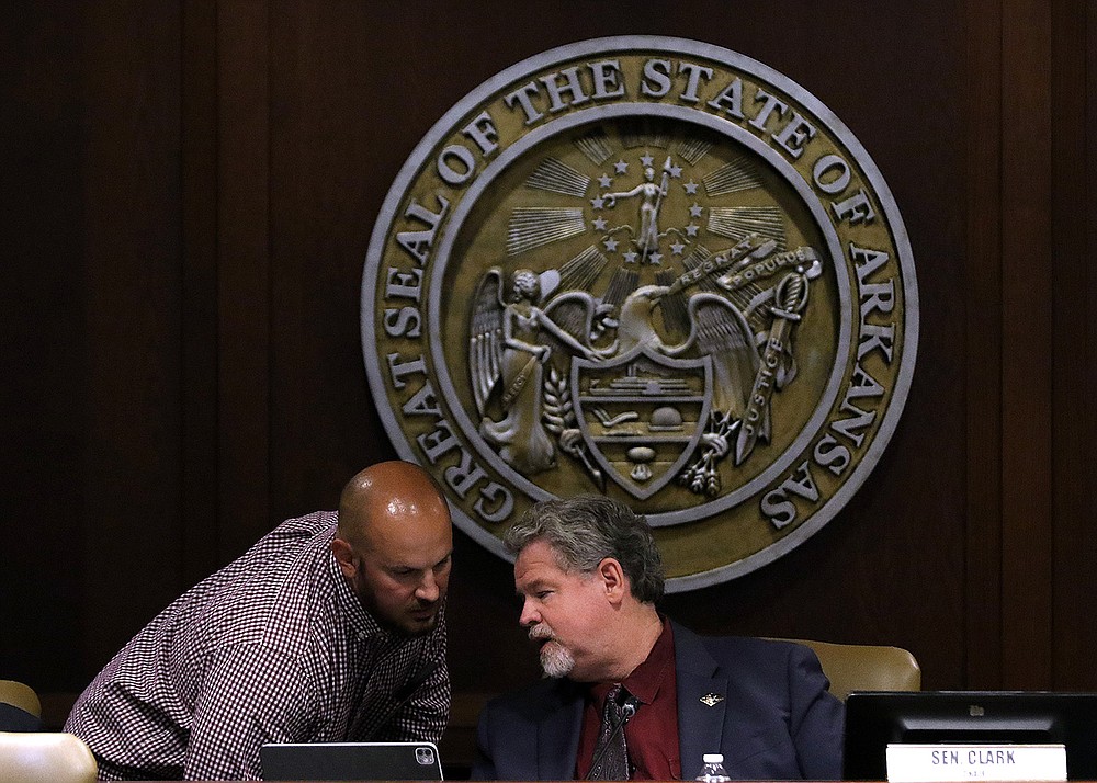 Sen. Trent Garner (left), R-El Dorado, talks with committee chair, Sen Alan Clark, R-Lonsdale, during a meeting of the joint House and Senate Committee on Insurance and Commerce on Tuesday, Aug. 10, 2021, at the state Capitol in Little Rock.
(Arkansas Democrat-Gazette/Thomas Metthe)