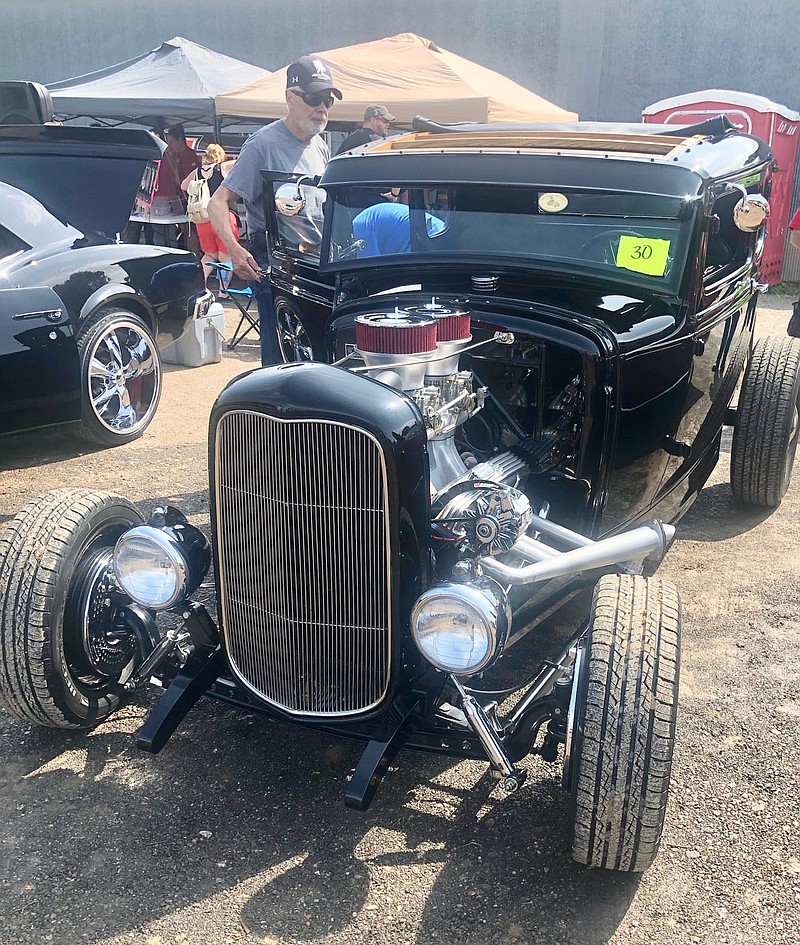 Westside Eagle Observer/SUSAN HOLLAND
A car enthusiast examines one of the vehicles entered in the 2019 Gravette Day car show. The popular car, truck and bike show will be held this year from 10 a.m. to 2 p.m. Saturday, August 14, at the old bus barn property on Charlotte Street S.E.