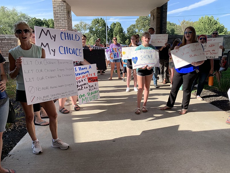 People chant "my child, my choice" Wednesday outside a Bentonville School Board special meeting concerning wearing masks in schools. (NWA Democrat-Gazette/Mary Jordan)