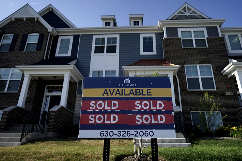 An advertising sign for building land stands in front of a new home construction site in Northbrook, Ill., Wednesday, June 23, 2021. Mortgage rates fell for the fourth straight week, Thursday, July 22, undercut by worries that the surging delta coronavirus variant and the worsening pandemic in hotspots around the world could derail what has been a strong economic recovery.  (AP Photo/Nam Y. Huh)