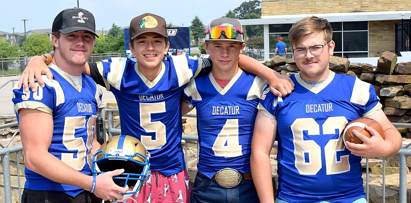 Westside Eagle Observer/MIKE ECKELS
Part of the Decatur Bulldog eight-man football team attends the football media day event at Arvest Ball Park in Springdale Aug. 3. Members include Waylon Harrington (left), Kayden Burr, Landon Watson and Mason Potter.