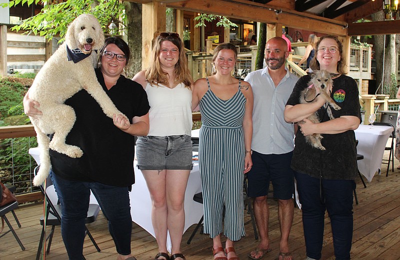 Cecil (from left), Kristen McCray, Megan Burlingame, Taylor and Matthew Arsenault, Kaitlin Thulin and Pip enjoy the Dog Days of Summer benefit for the Humane Society of the Ozarks on Aug. 1 at Sassafras Springs Vineyard and Winery in Springdale.
(NWA Democrat-Gazette/Carin Schoppmeyer)