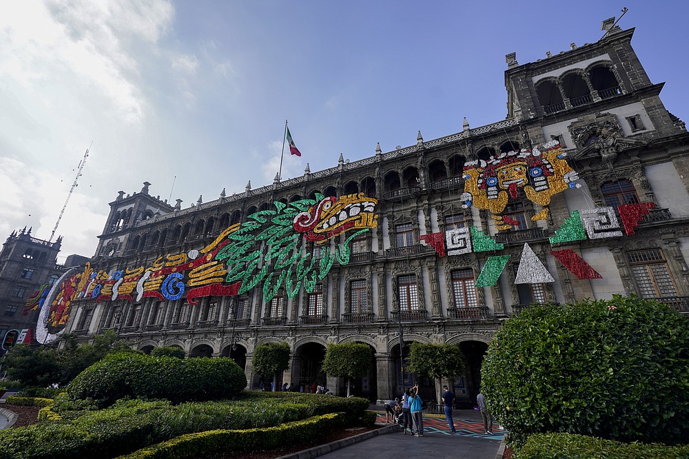 An image of the Pre-columbian god Quetzalcoatl adorns a building at Mexico City´s main square the Zocalo, Monday, Aug. 9, 2021. Mexico City is preparing for the 500 anniversary of the fall of the Aztec capital of Tenochtitlan, today´s Mexico City, on Aug. 13, 2021. (AP Photo/Eduardo Verdugo)