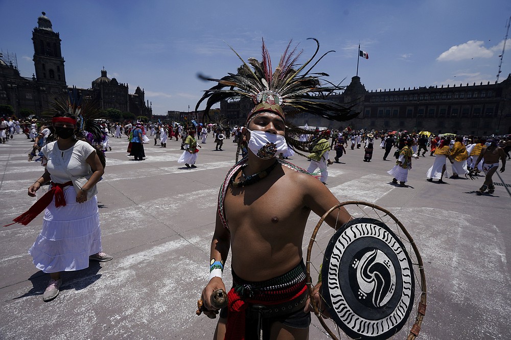 Mexican dancers perform during a ceremony as part of the commemoration marking the 700 year anniversary of the founding of the Aztec city of Tenochtitlan, known today as Mexico City, in Mexico City, Monday, July 26, 2021, amid the new coronavirus pandemic. (AP Photo/Fernando Llano)