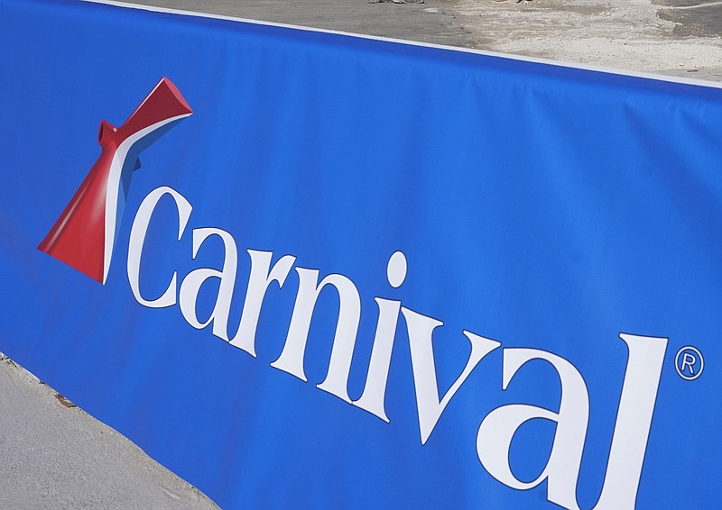 FILE - This Jan. 29, 2021 file photo shows a Carnival Cruise Line sign at PortMiami in Miami. The Belize Tourism Board says 27 people aboard a Carnival cruise tested positive for COVID-19 just before the ship made a stop in Belize City. The positive cases it reported Wednesday, Aug. 12, were among 26 crew members and one passenger on the Carnival Vista, which is carrying over 1,400 crew and nearly 3,000 passengers.  (AP Photo/Lynne Sladky, File)