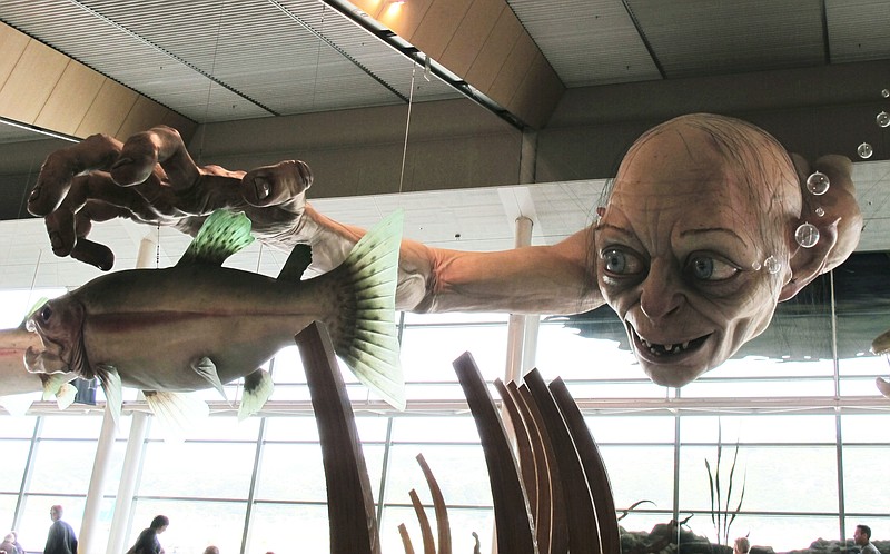 FILE - In this Nov. 24, 2012, file photo, a giant sculpture of Gollum, a character from "The Hobbit" is displayed in the Wellington Airport. New Zealand has long been associated with "The Lord of the Rings" but with the filming of a major new television series suddenly snatched away, the nation has become more like Mordor than the Shire for hundreds of workers. (AP Photo/Nick Perry, File)
