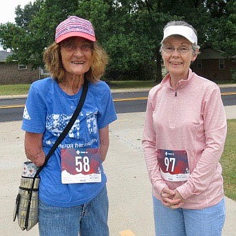 Westside Eagle Observer/SUSAN HOLLAND
Susan Hazard and her friend Ruth Poemoceah pause for a photo just before the start of the Gravette Day 5K. Poemoceah travels to Rogers to walk with Susan once a week and asked if she would like to join her in the race. Susan readily accepted.