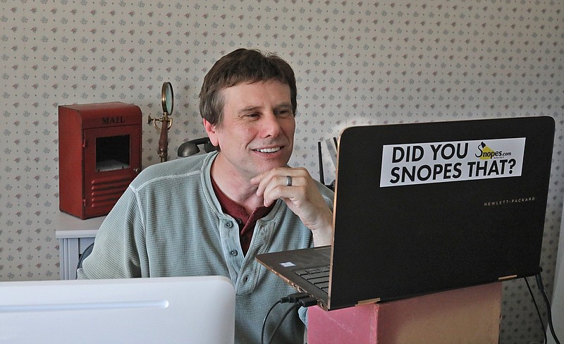 FILE - This Sept. 25, 2018 file photo shows David Mikkelson, founder of Snopes, the site that tracks fakery on the web, in his home office in Tacoma, Wash. The co-founder, CEO and a major shareholder of the fact-checking site admitted to plagiarizing from dozens of articles done by mainstream news outlets over several years, calling the appropriations &#x201c;serious lapses in judgment.&#x201d; From 2015 to 2019, and possibly even earlier, Mikkelson included material lifted from the Los Angeles Times, The Guardian and others to scoop up web traffic, according to BuzzFeed News, which broke the story Friday, Aug. 13, 2021. (Greg Gilbert/The Seattle Times via AP, File)