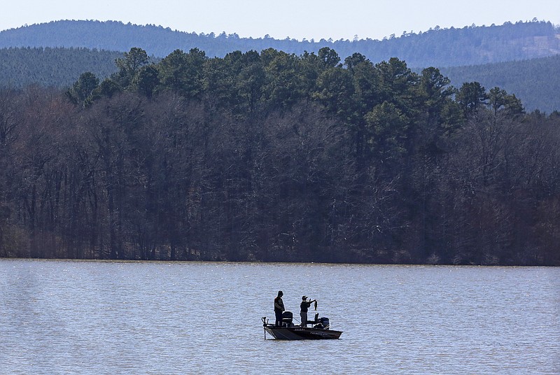 A fisherman shows off his catch Thursday March 4, 2021 on Lake Maumelle in Pulaski County.(Arkansas Democrat-Gazette/Staton Breidenthal)