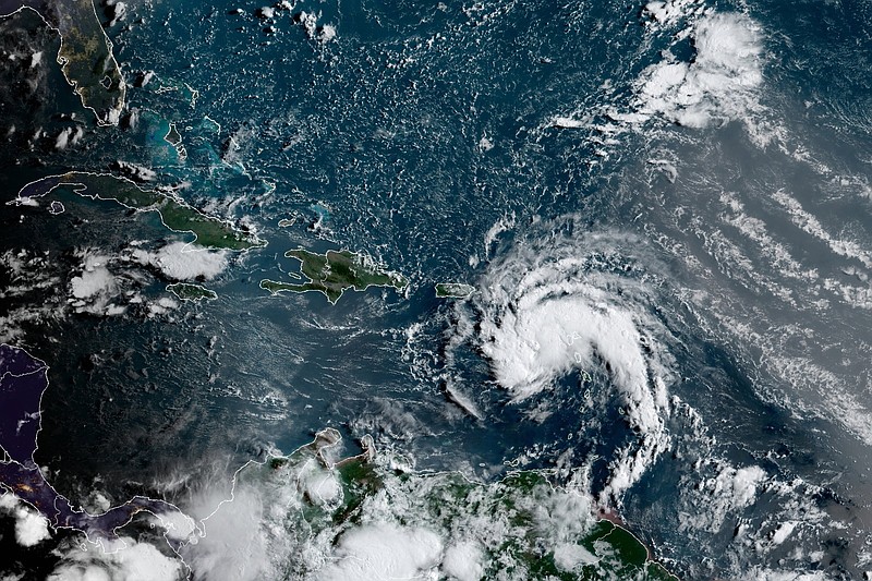 This satellite image provided by the National Oceanic and Atmospheric Administration (NOAA) shows a tropical storm east of Puerto Rico in the Caribbean, at 7:50am EST, Tuesday, Aug. 10, 2021. The National Hurricane Center issued tropical storm warnings for the U.S. Virgin Islands and Puerto Rico, where forecasters expected the potential cyclone to strengthen Tuesday into the sixth named storm, Fred, of the Atlantic hurricane season. (NOAA/NESDIS/STAR GOES via AP)
