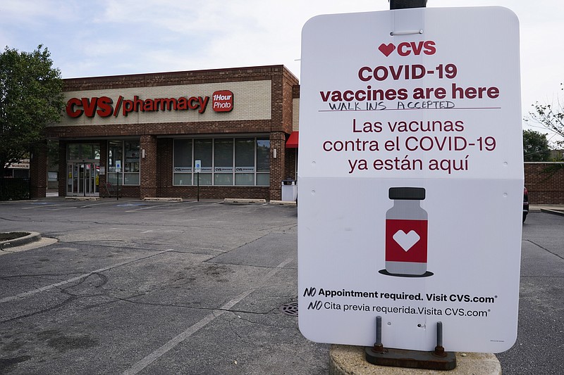 An information sign regarding COVID-19 vaccines is seen outside of a CVS store in Chicago, Ill., Friday, Aug. 13, 2021. The Centers for Disease Control and Prevention gave final approval Friday to start administering Covid-19 booster shots to Pfizer and Moderna vaccine recipients hours after a key panel unanimously voted to endorse third doses for immunocompromised Americans. (AP Photo/Nam Y. Huh)