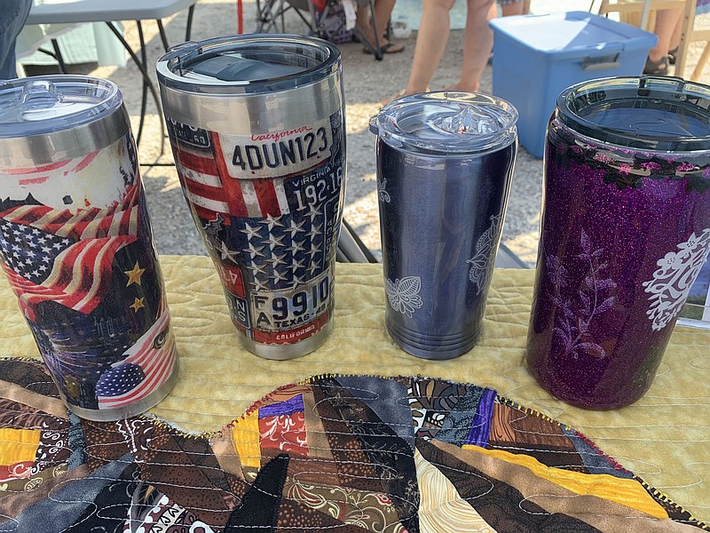 SALLY CARROLL/SPECIAL TO MCDONALD COUNTY PRESS These tumbler cups are created, in part, with pieces of fabric. The tumblers are sold through TT Creations, a vendor at Mountain Happenings at Sims Corner.