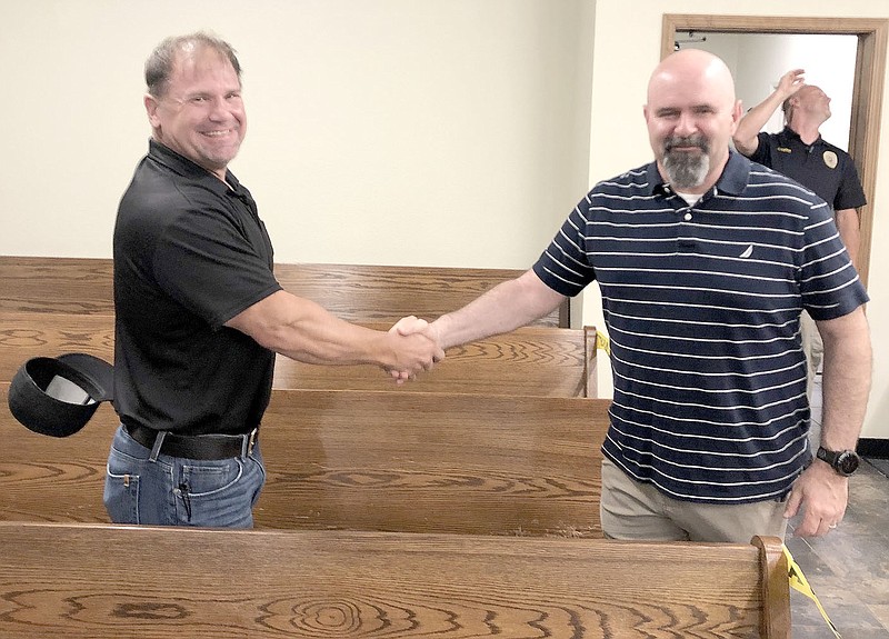 COURTESY PHOTO
District Judge Graham Nations, right, congratulates Chris Powell as a new member of Prairie Grove City Council. Nations performed the oath of office for Powell.