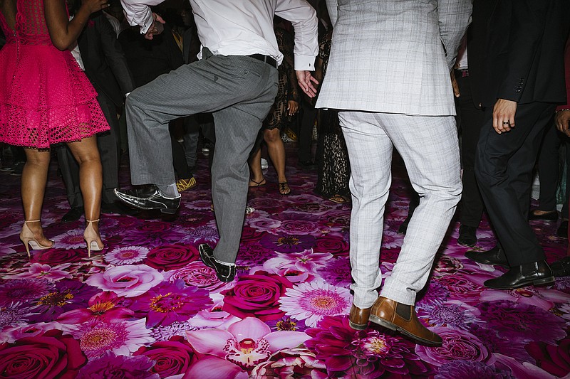 FILE &#x2014; Guests dance at a wedding in Piru, Calif., Sept. 1, 2019. After months of couples postponing and paring down their wedding plans, the season of celebrating nuptials is finally in full swing again and DJs are in high demand and in short supply. (Philip Cheung/The New York Times)