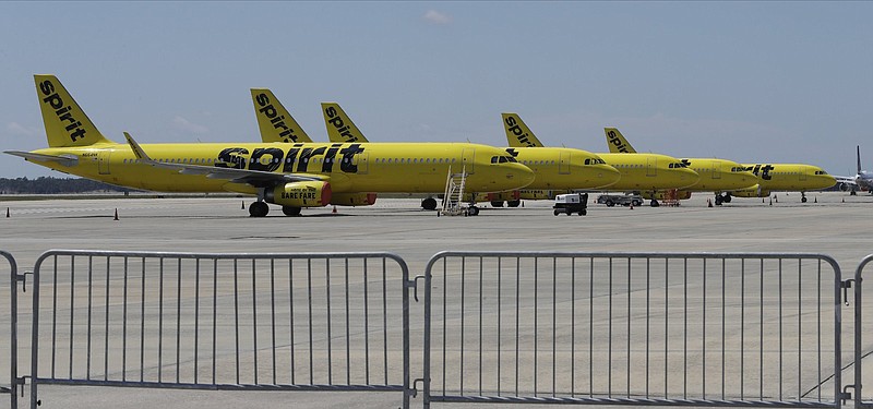 A line of Spirit Airlines jets sit on the tarmac at the Orlando International Airport Wednesday, May 20, 2020, in Orlando, Fla. Air travel is down during the coronavirus outbreak.