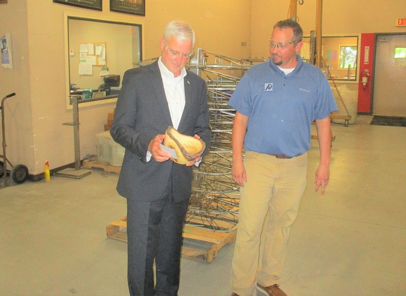 Marc Hayot/Siloam Sunday Alternative Design President/CEO Grant Loyd (right) presents U.S Representative Stephen Womack (AR-3) with a bowl made of Walnut wood during Womack’s visit on Wednesday. The congressman visited Alternative Design as part of his small business tour of Northwest Arkansas.