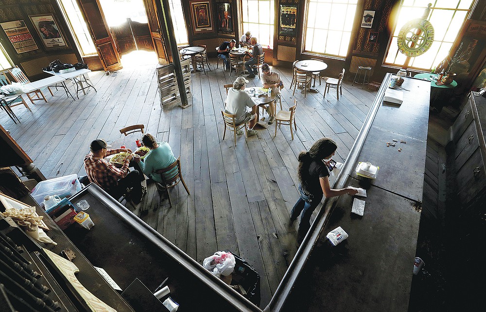 The crew breaks for lunch, using the main saloon for their meal at the Mescal Movie Set in Benson, Ariz. (Kelly Presnell/Arizona Daily Star via AP)