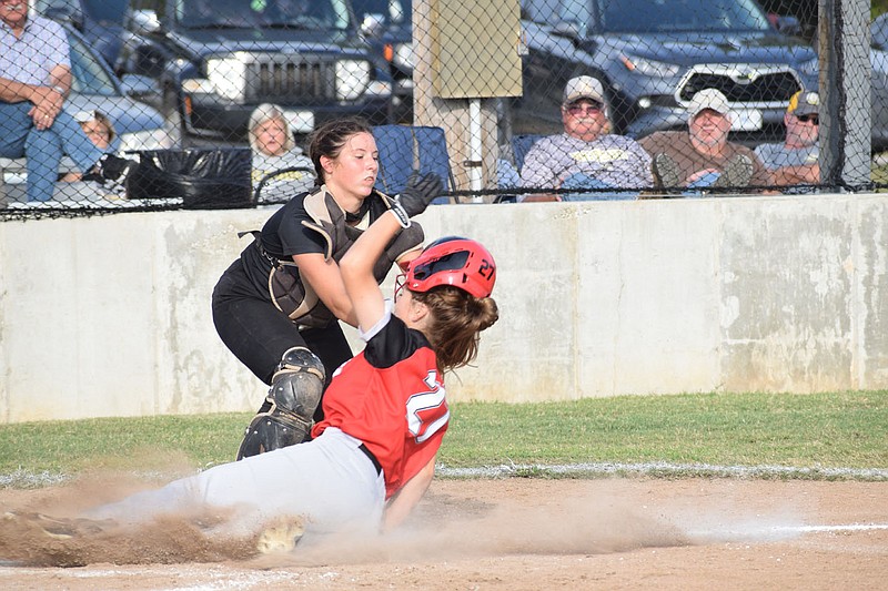 RICK PECK/FILE PHOTO
Nevaeh Dodson slides into home during a softball game last season.