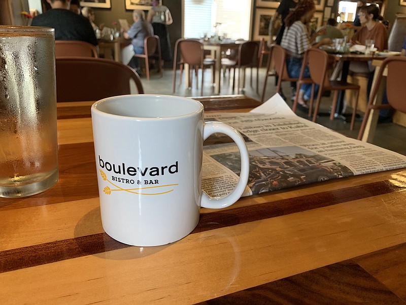 Brunch accompaniments at Boulevard Bistro in Little Rock's Pulaski Heights: A cup of strong coffee and a Sunday newspaper. (Arkansas Democrat-Gazette/Eric E. Harrison)