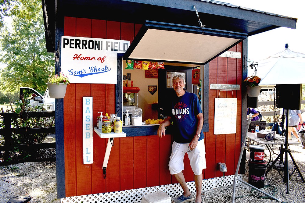 MARK HUMPHREY  ENTERPRISE-LEADER/Sam Peronni, a retired federal prosecutor/attorney, poses next to the concession stand after hosting a little league baseball tournament dubbed the Peronni Invitational Saturday and Sunday on his property in the Weddington area. The tournament served as a fundraiser to address Alzheimer's disease which affects Sam's wife, Pat Peronni. Instead of charging admission all proceeds raised through concession sales go towards defeating the disease.