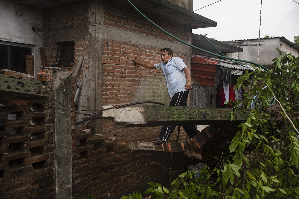 A man inspects the damage after a part of his home was toppled by the winds drought on by Hurricane Grace, in Tecolutla, Veracruz State, Mexico, Saturday, Aug. 21, 2021. Grace hit Mexico&#x2019;s Gulf shore as a major Category 3 storm before weakening on Saturday, drenching coastal and inland areas in its second landfall in the country in two days. (AP Photo/Felix Marquez)