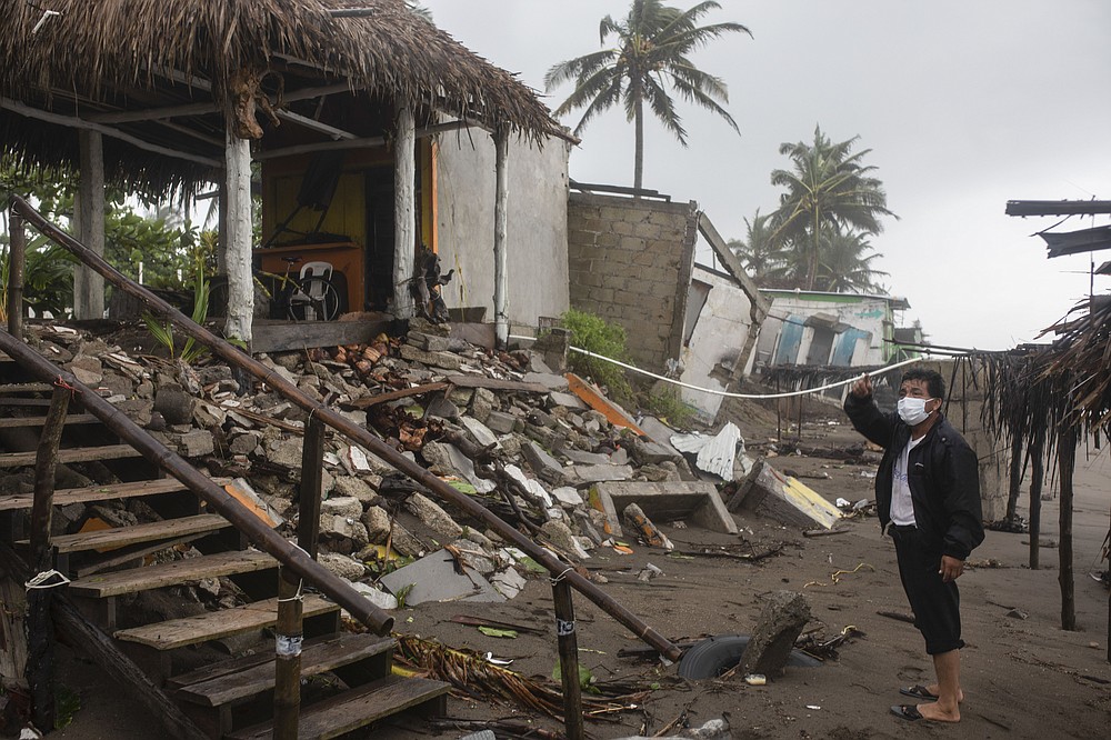 A man inspects the damage after a part of his home was toppled by winds brought on by Hurricane Grace, in Tecolutla, Veracruz State, Mexico, Saturday, Aug. 21, 2021. Grace hit Mexico&#x2019;s Gulf shore as a major Category 3 storm before weakening on Saturday, drenching coastal and inland areas in its second landfall in the country in two days. (AP Photo/Felix Marquez)